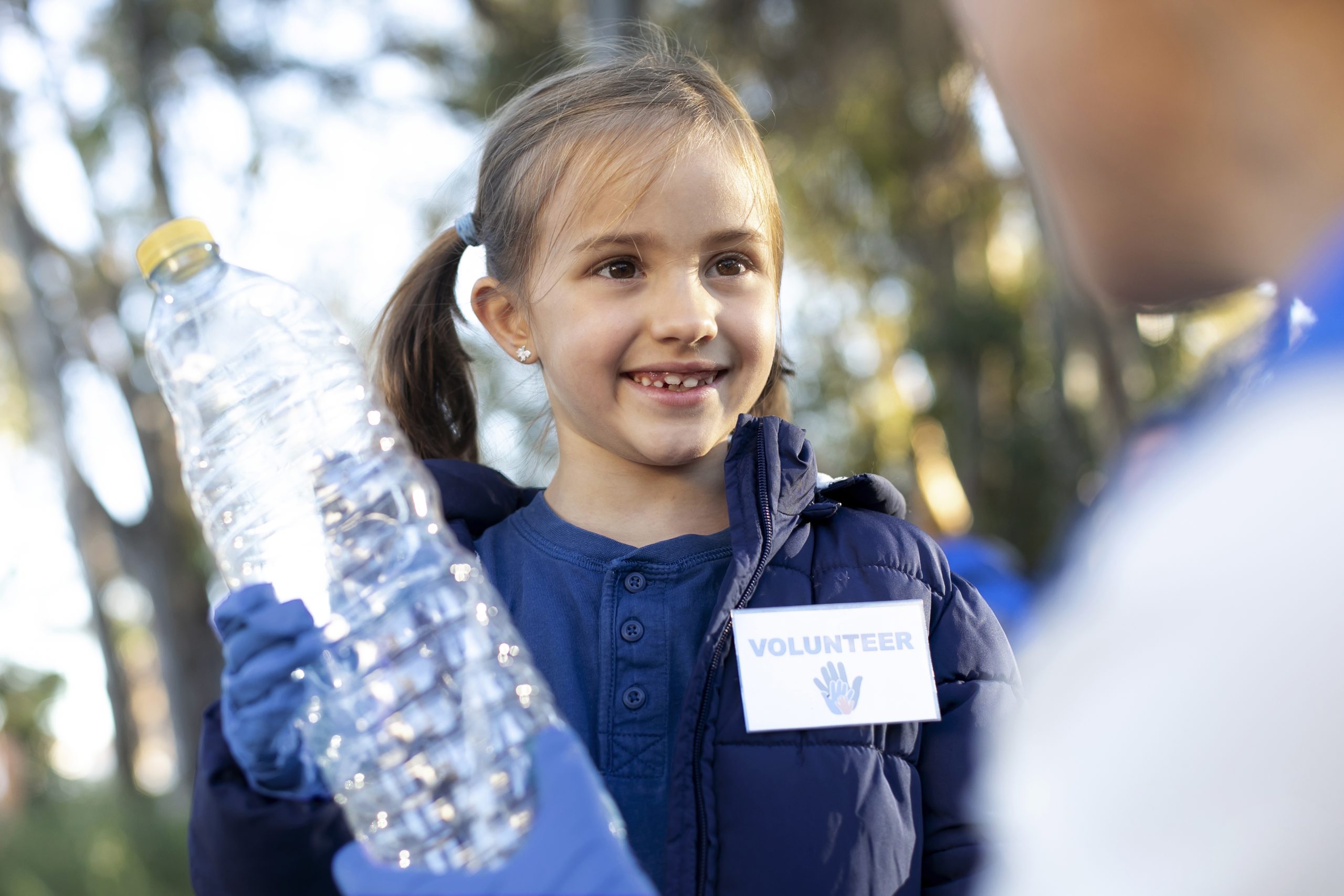 close up girl holding plastic bottle