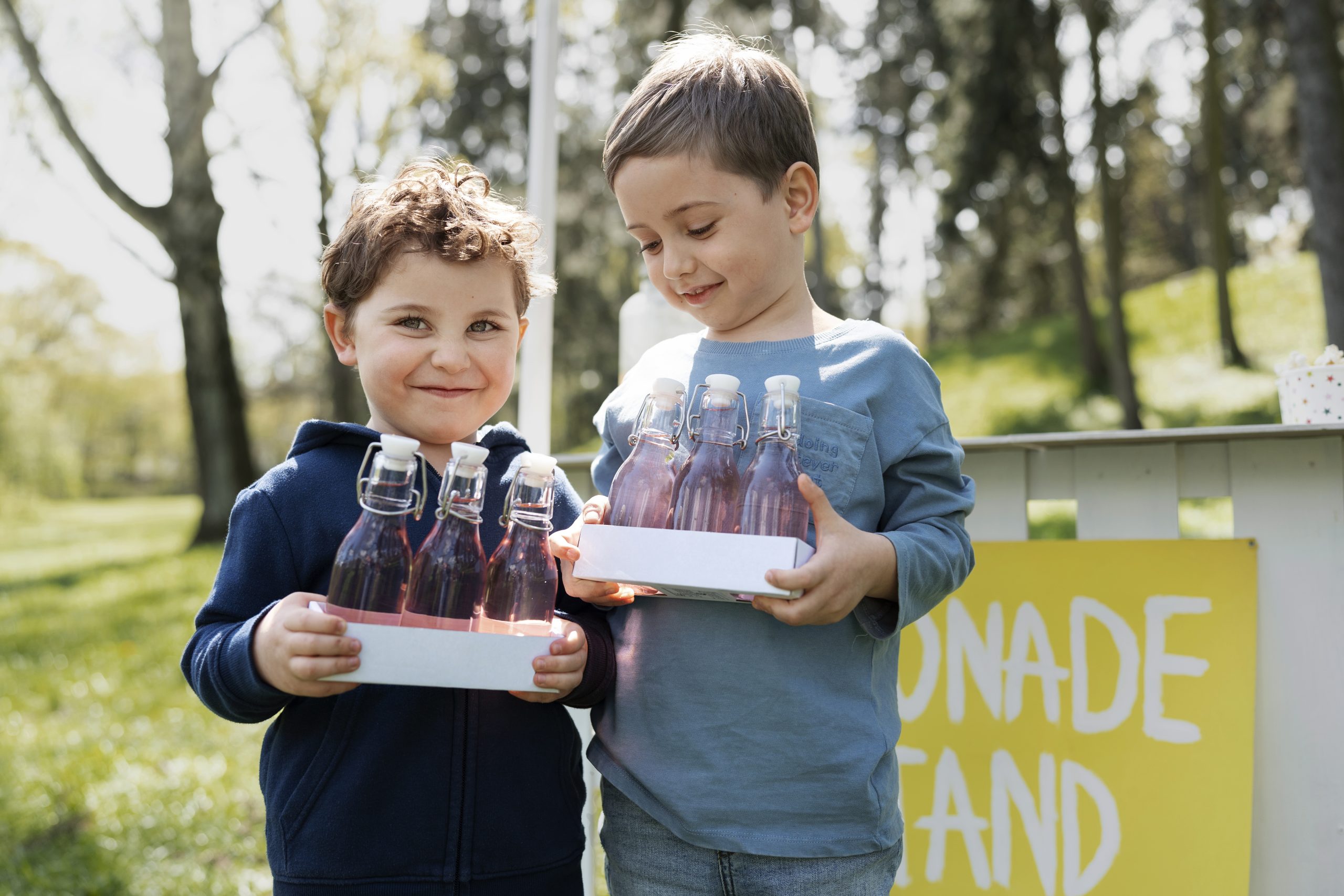 smiley little kids with lemonade front view